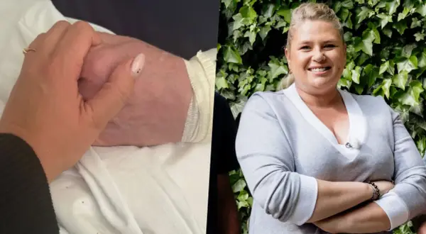 Elżbieta Romanowska trzyma za rękę bliską osobę, być może swojego męża, w trudnym momencie.