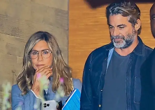 Jennifer Aniston w okularach i mężczyzna z siwą brodą.